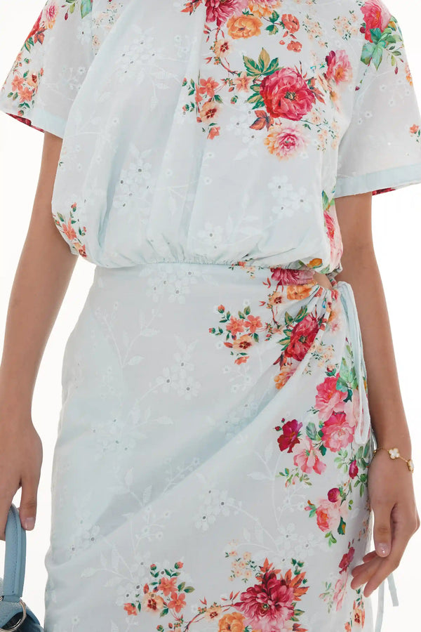 Close-up of Pretty Pixie ivory floral wrap long-sleeve mini dress, fabric detail