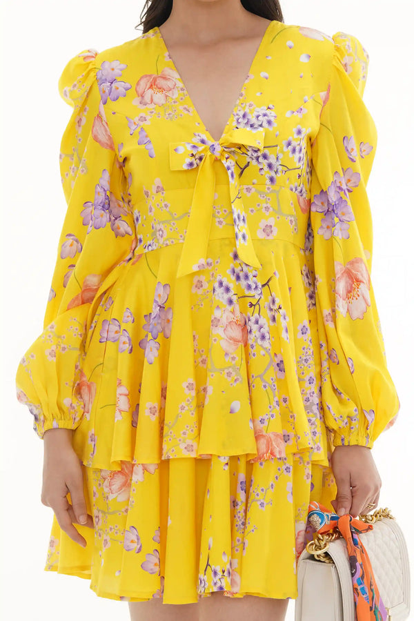 Close-up of Pretty Pixie marigold tie-neck ruffle mini dress