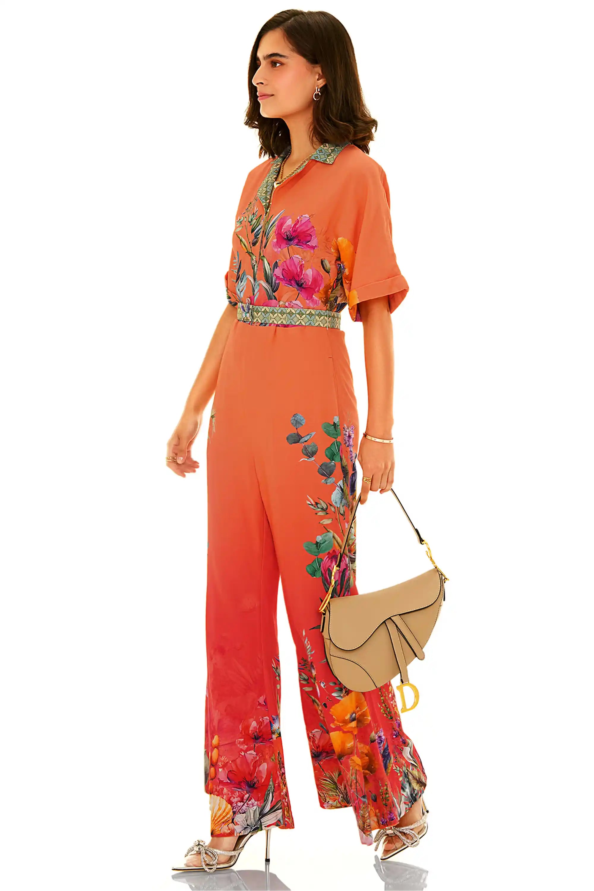 Side view of orange floral wide-leg jumpsuit with vibrant botanical prints