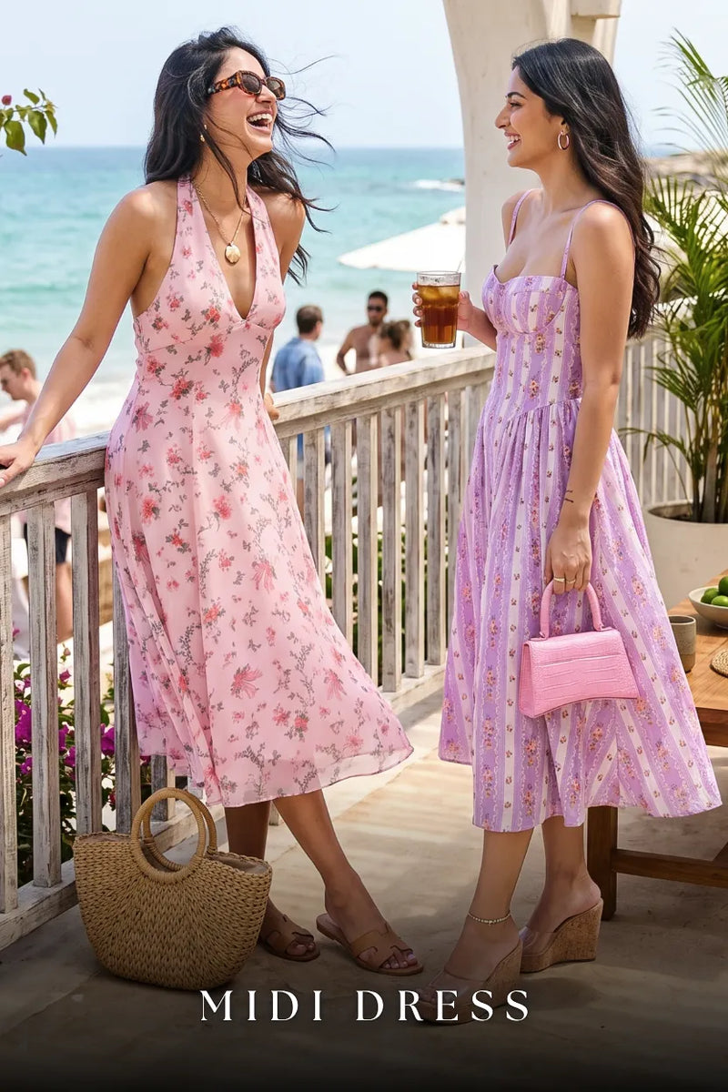 Women in pink and lavender floral halter midi dresses at beach resort with ocean view; organic cotton vacation and beach dresses for women
