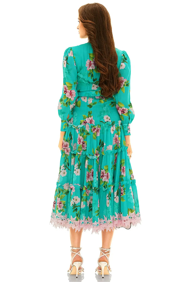 Back view of turquoise floral long sleeve tiered midi dress with lace trim