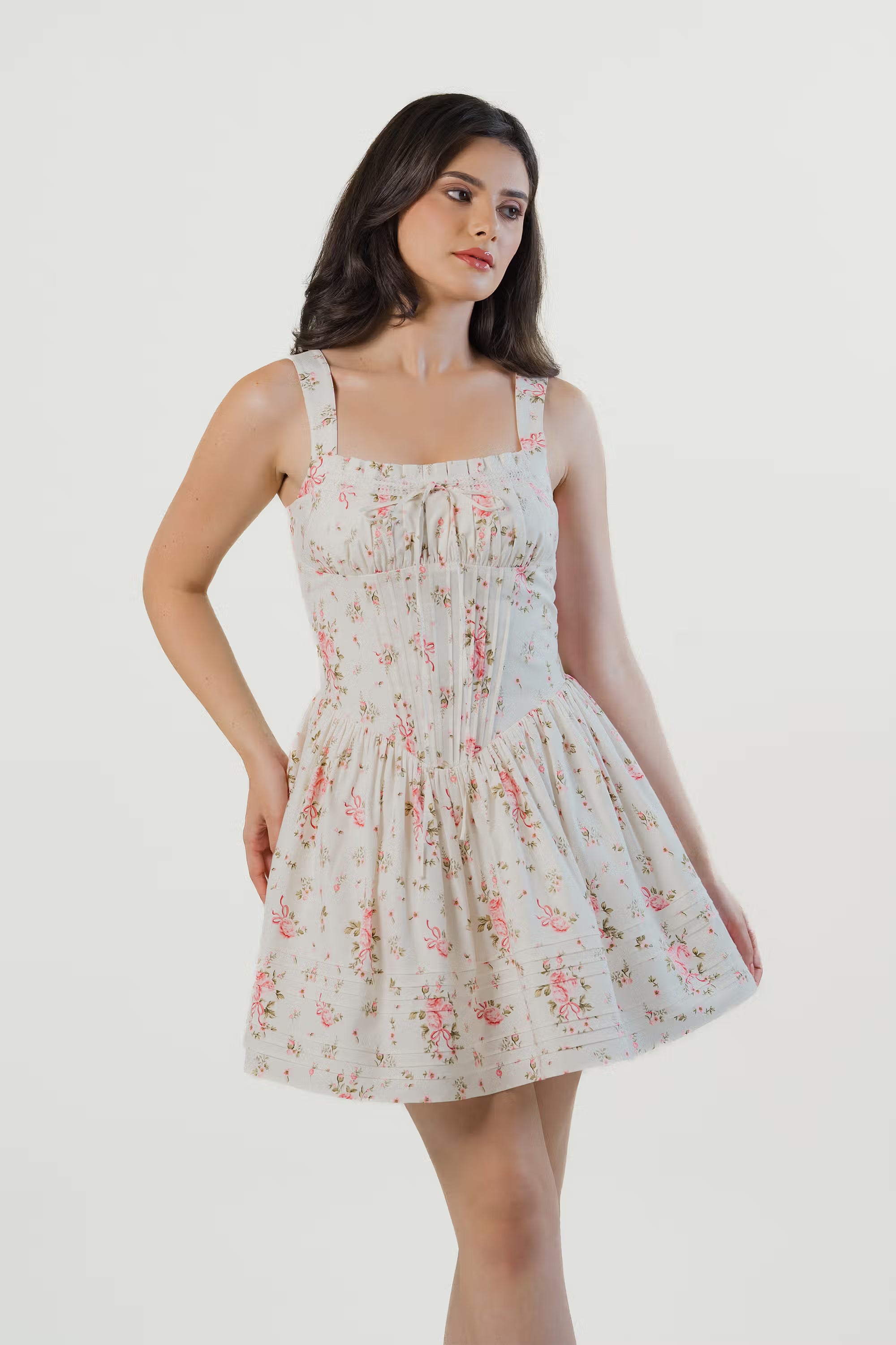 white floral corset mini dress with puff sleeves and flared hem, styled with strappy heels