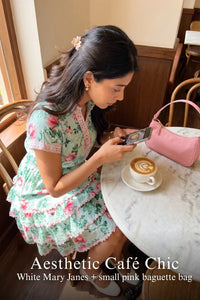 Woman in Pretty Pixie aqua blossom floral tiered ruffle mini dress styled for a styled look