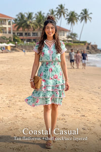 Woman in Pretty Pixie aqua blossom floral tiered ruffle mini dress styled for a styled look