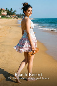 Woman in Pretty Pixie pastel blue floral halter mini dress styled for a styled look