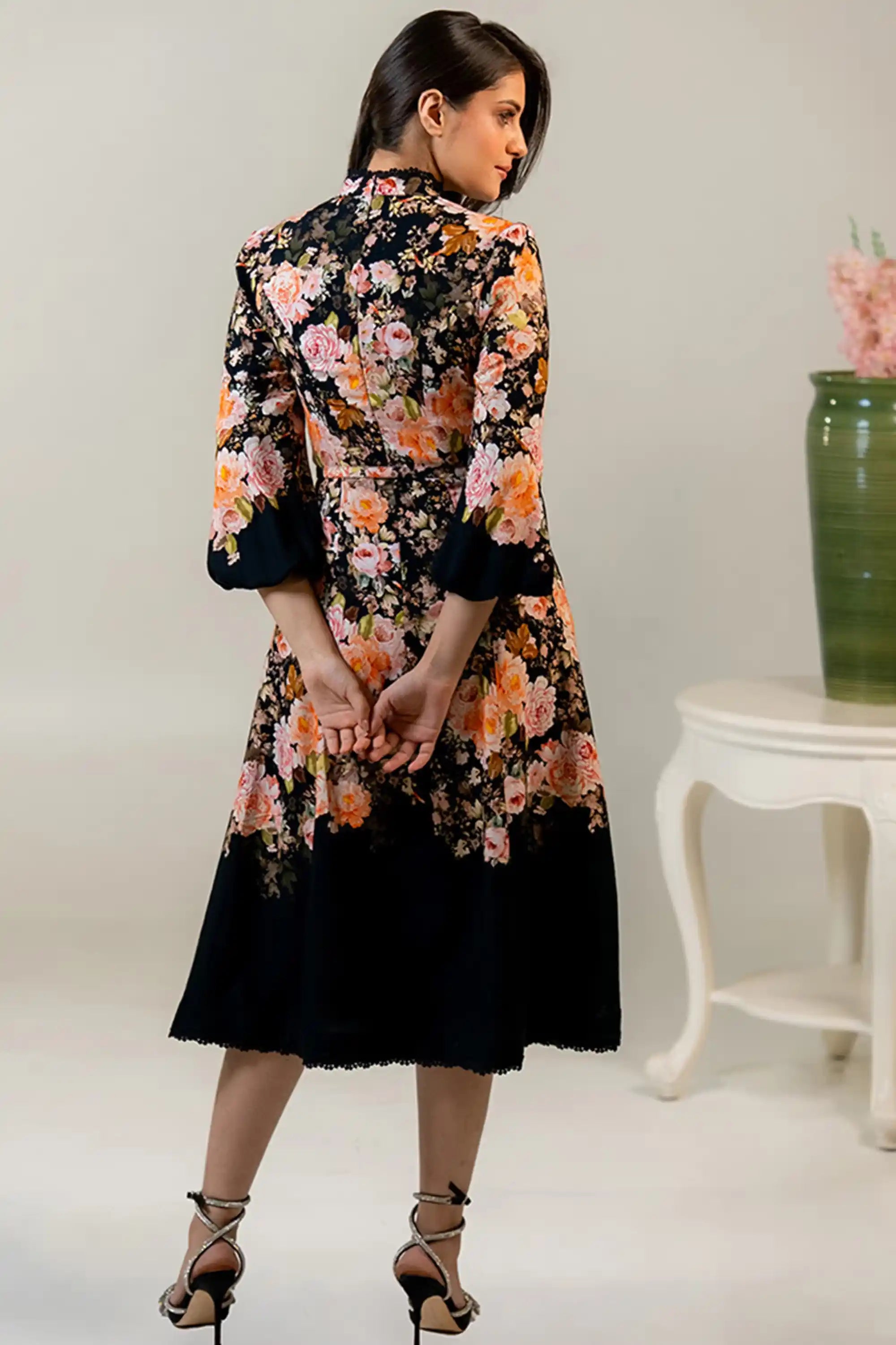 Back view of black floral midi dress with long sleeves