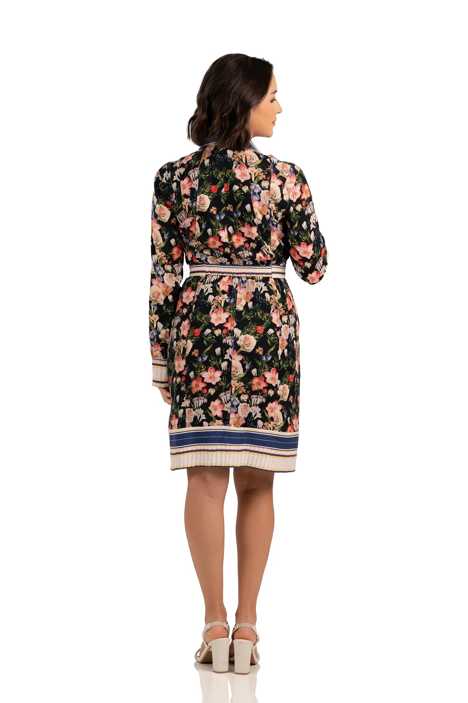 Back view of floral belted shirt dress with multicolor print, long sleeves, and striped hemline.