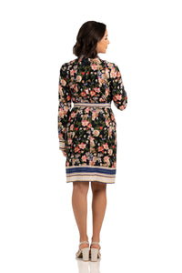 Back view of floral belted shirt dress with multicolor print, long sleeves, and striped hemline.