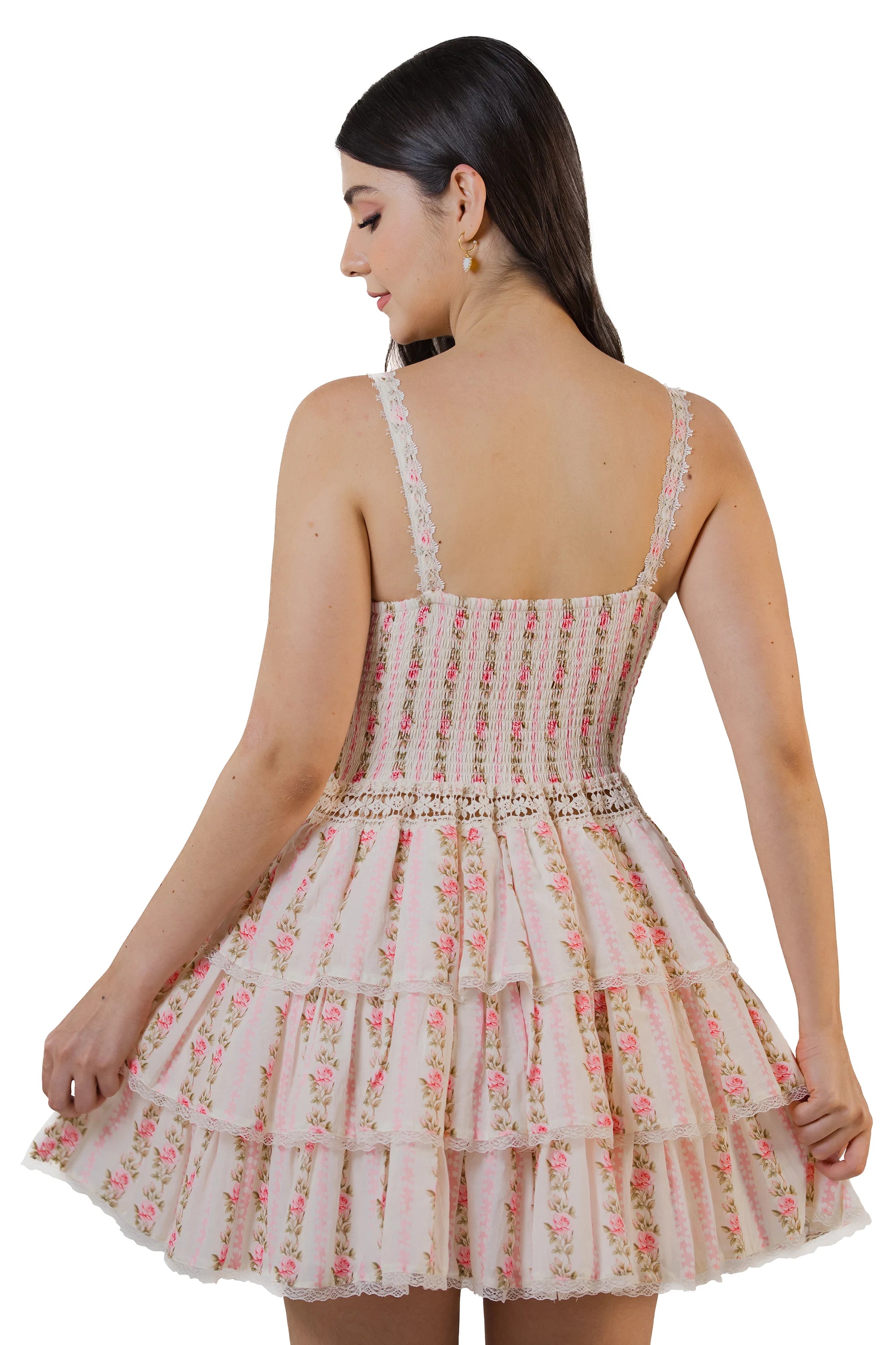 Back view of a pink floral tiered mini dress with lace straps, smocked bodice, and layered skirt for women.