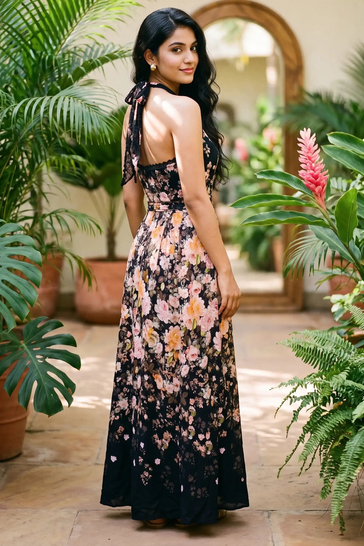 Back view of black floral halter maxi dress with open back; organic cotton women's evening occasion and party wear for women