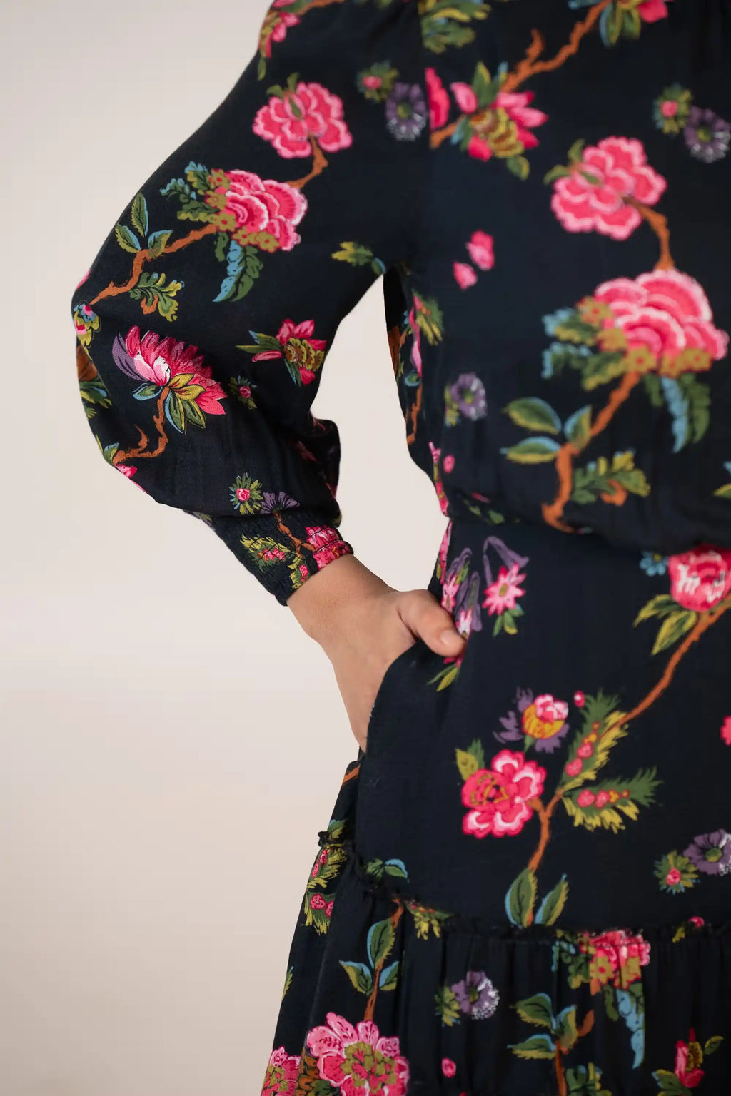 Black floral mini dress with lace trim and pocket detail