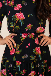 Closeup of pink floral lace-trim mini dress pattern on black base