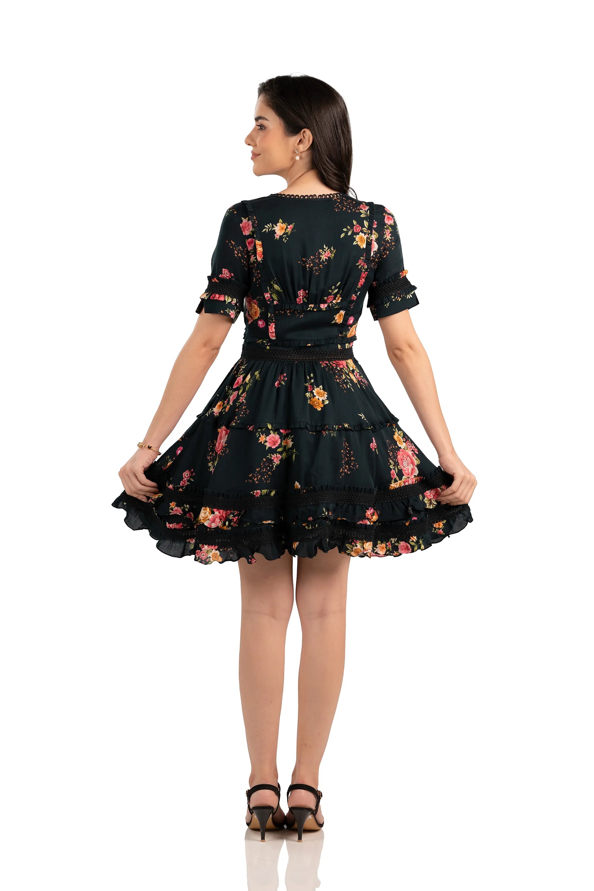Back view of tiered ruffle black floral mini dress with pink and yellow flower print, perfect for parties and date nights.