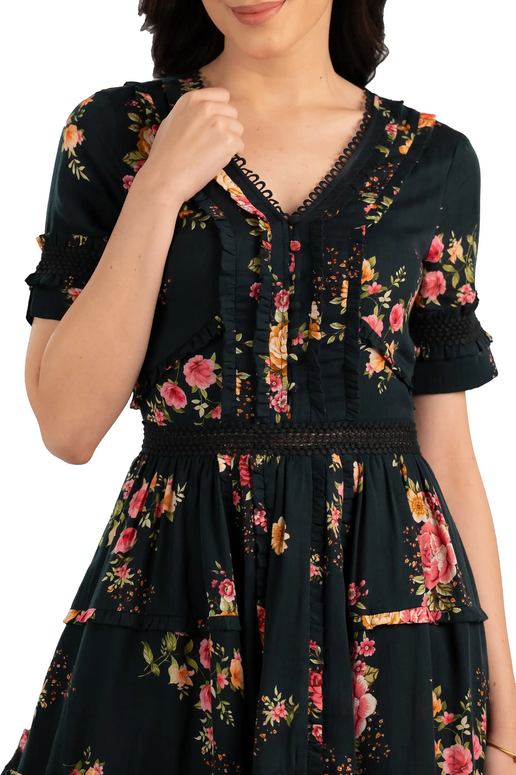 Close-up of floral V-neck mini dress showing ruffle detailing and rose flower print