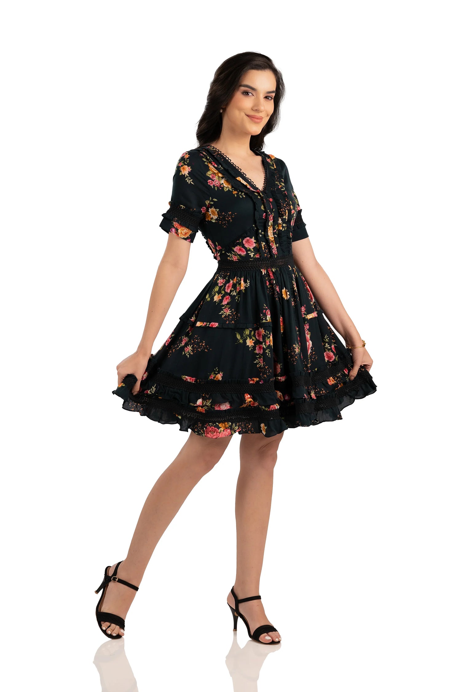 Side view of black floral mini dress with short sleeves, V-neckline, and ruffle hem