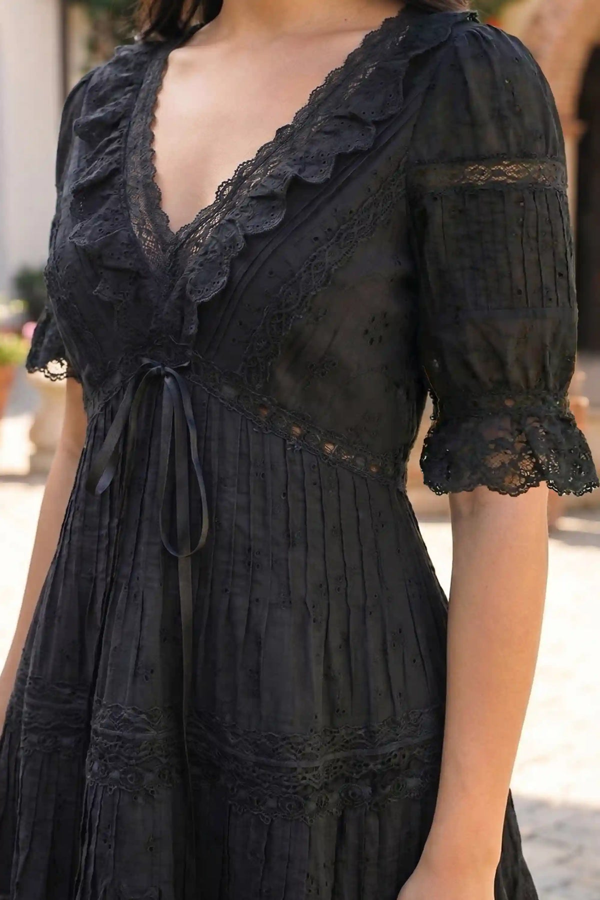 Pretty Pixie black lace pleated tiered mini dress detail view v-neck lace trim ribbon
