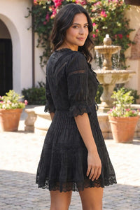 Pretty Pixie Black lace-trim pleated v-neck tiered mini dress for women, back view