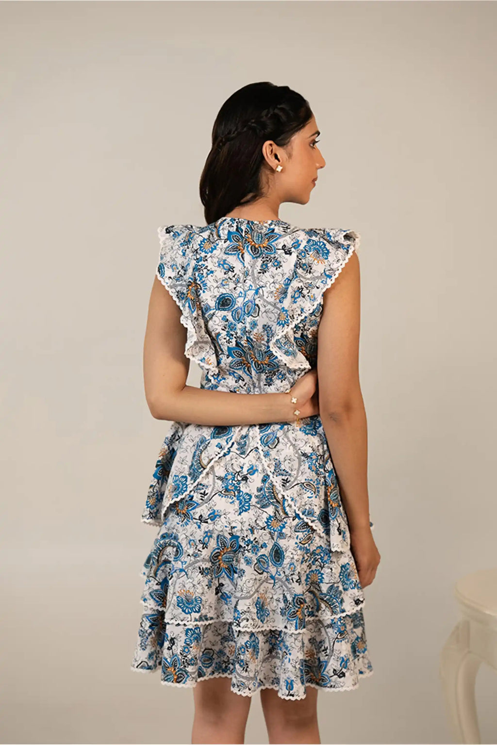 Back view of blue floral layered midi dress with ruffle detailing