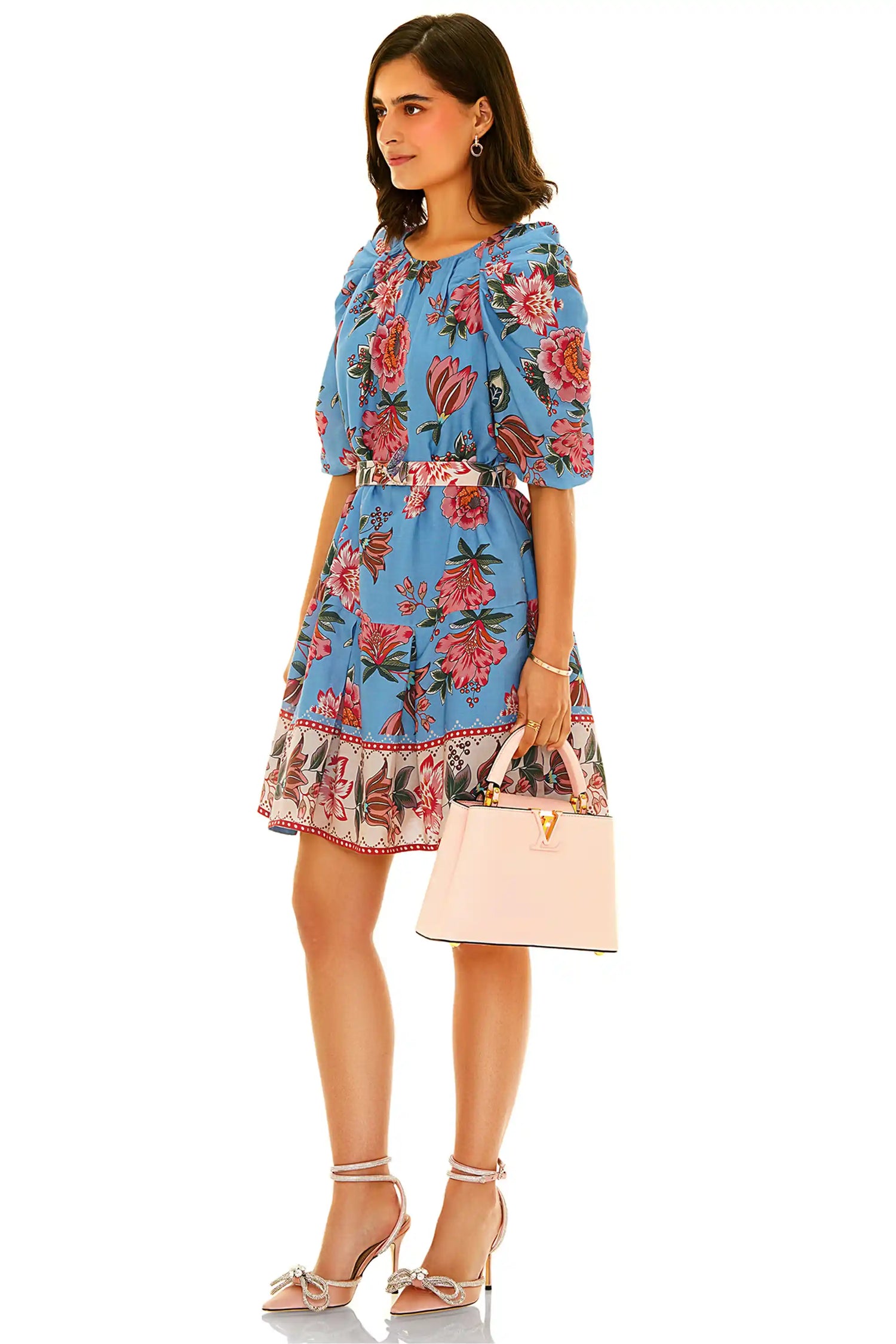 Side view of blue floral belted mini dress with puff sleeves