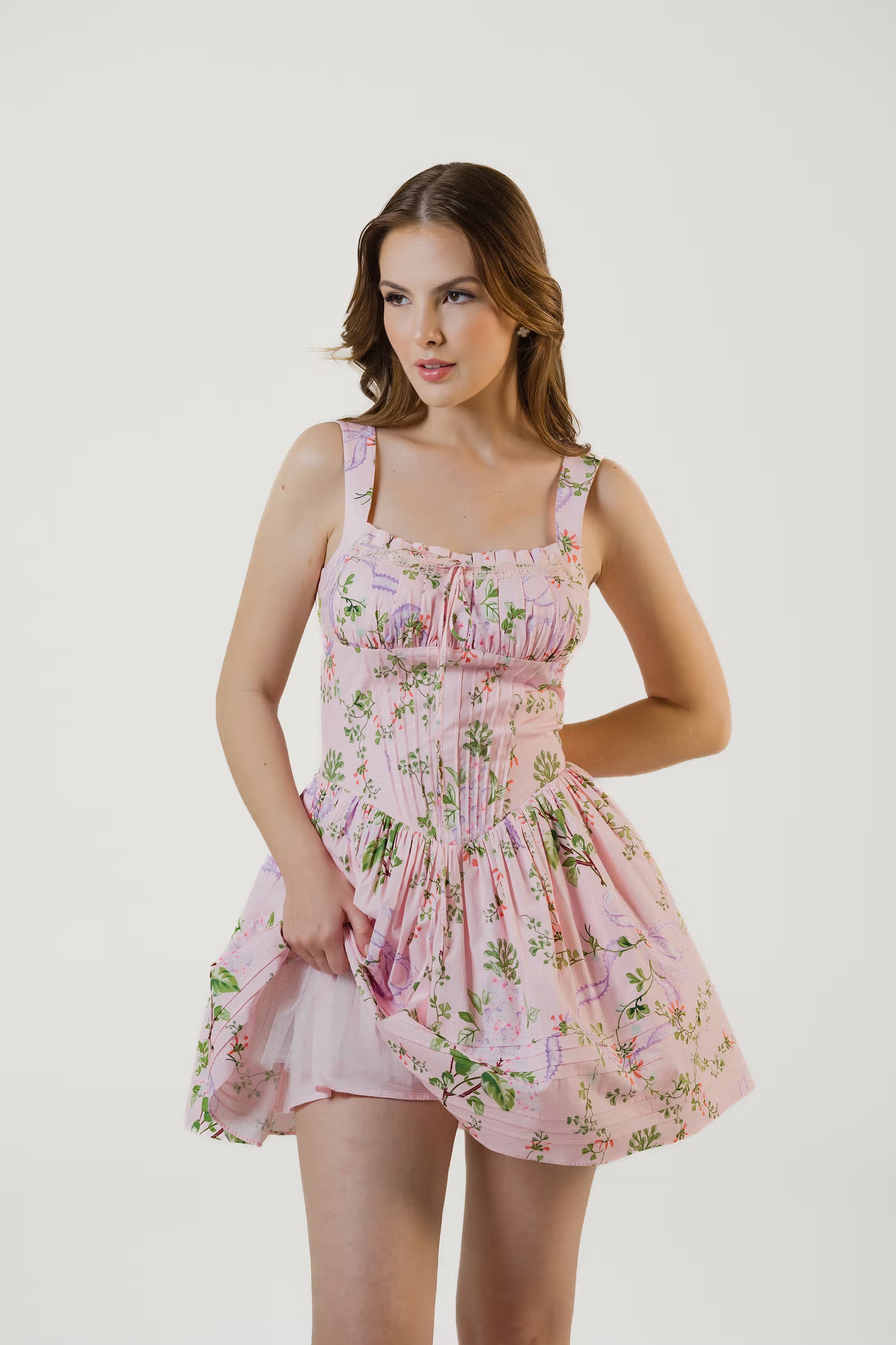 Front close-up of blush pink floral corset mini dress showing ruched bodice and lace detail