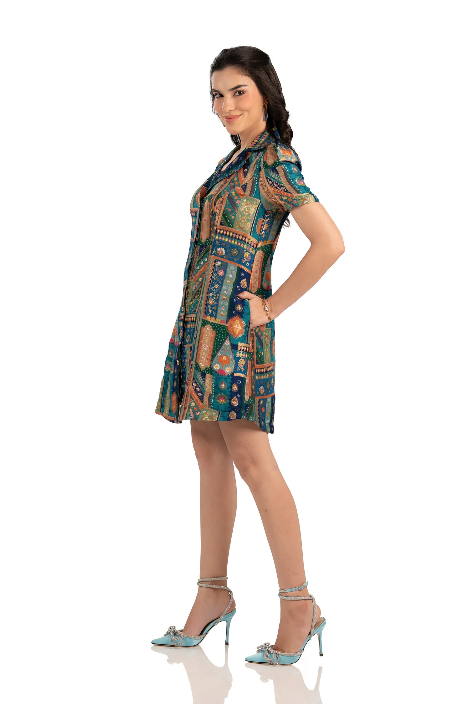 Side view of teal patchwork mini shirt dress with handy pockets