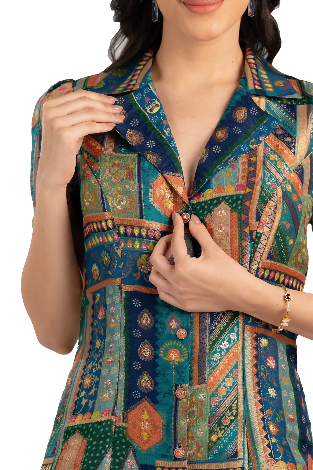 Close-up of notched collar and buttons on teal patchwork shirt dress