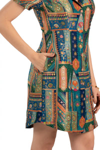 Close-up of pocket and button placket on teal patchwork mini dress