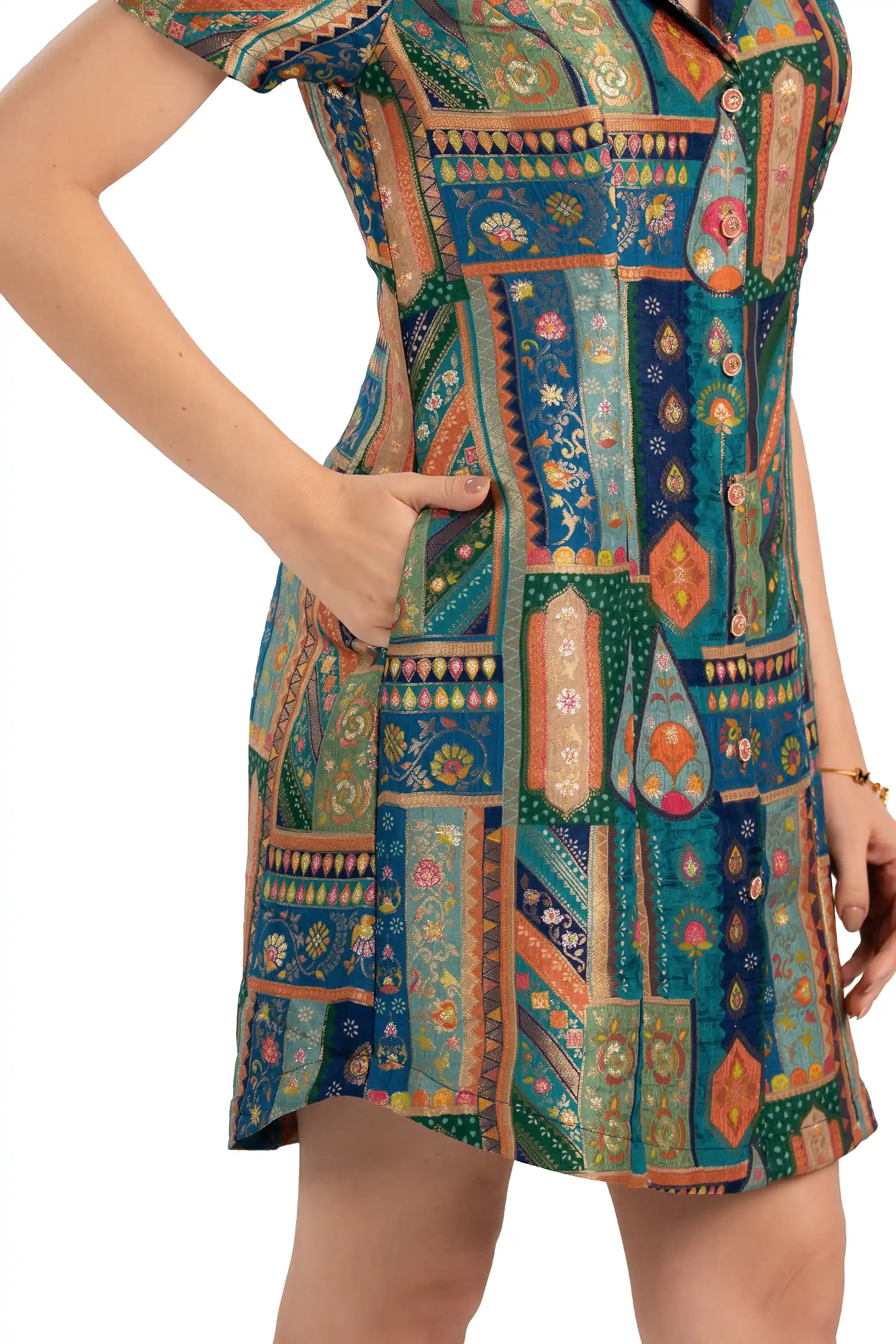 Close-up of pocket and button placket on teal patchwork mini dress
