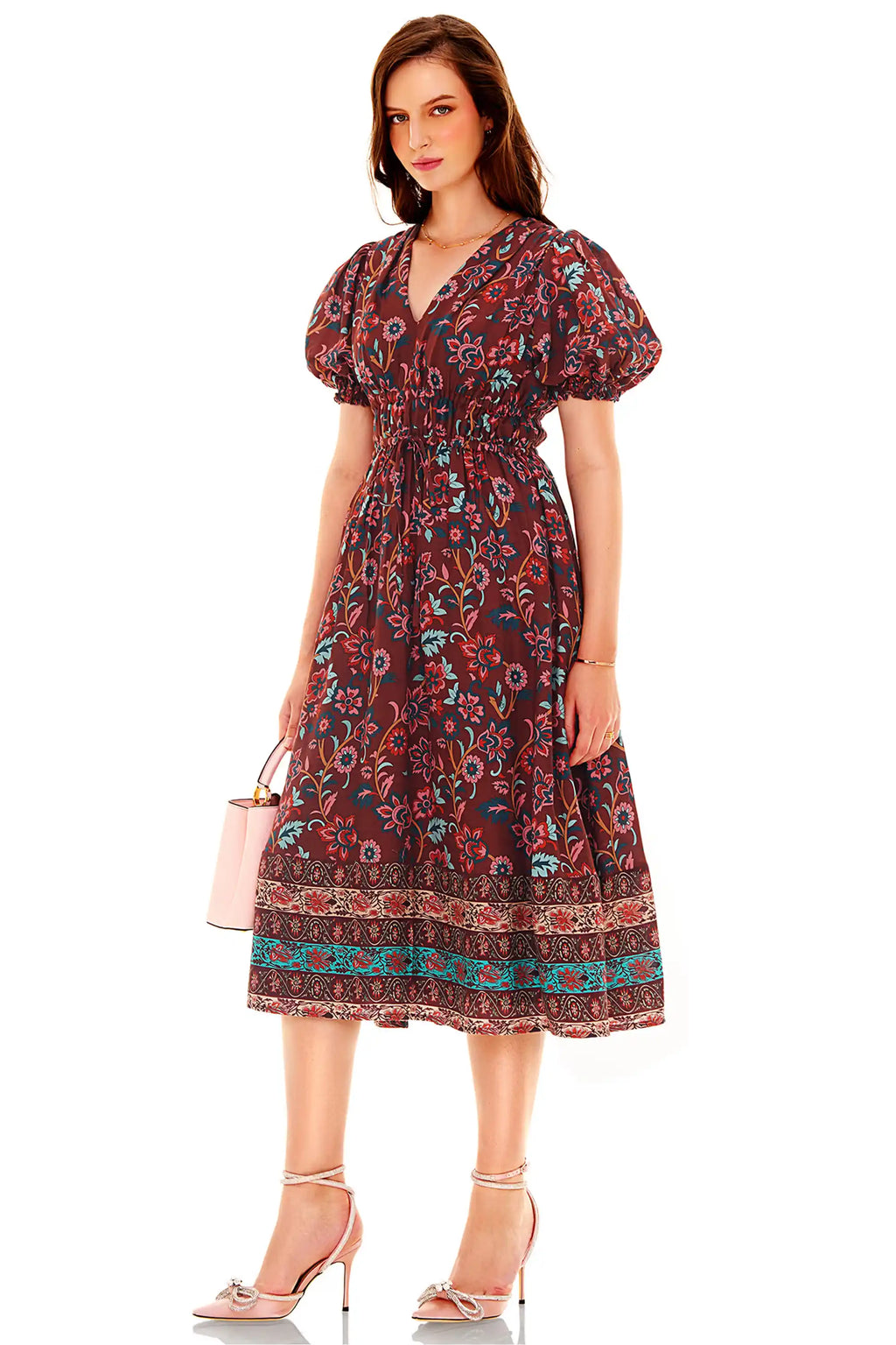 Woman in burgundy floral puff sleeve midi dress with shirred waist, side angle view