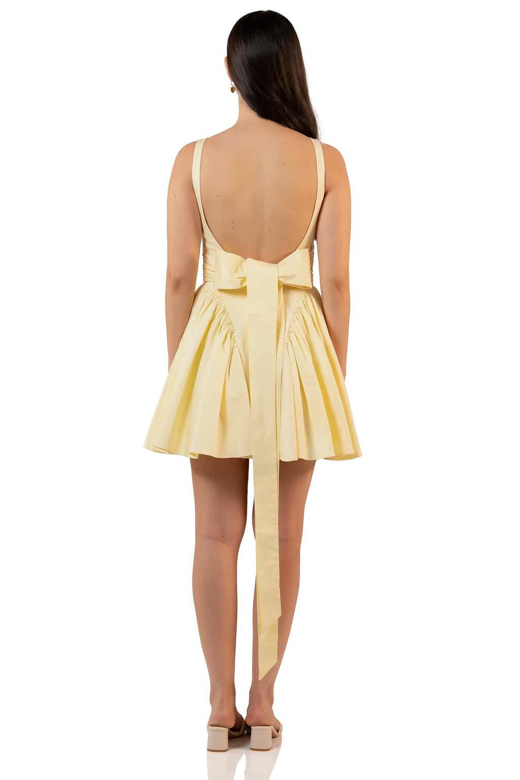 Back view of butter yellow mini dress with long bow tie
