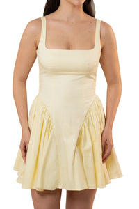 Gathered hip panel detail on butter yellow mini dress, close-up
