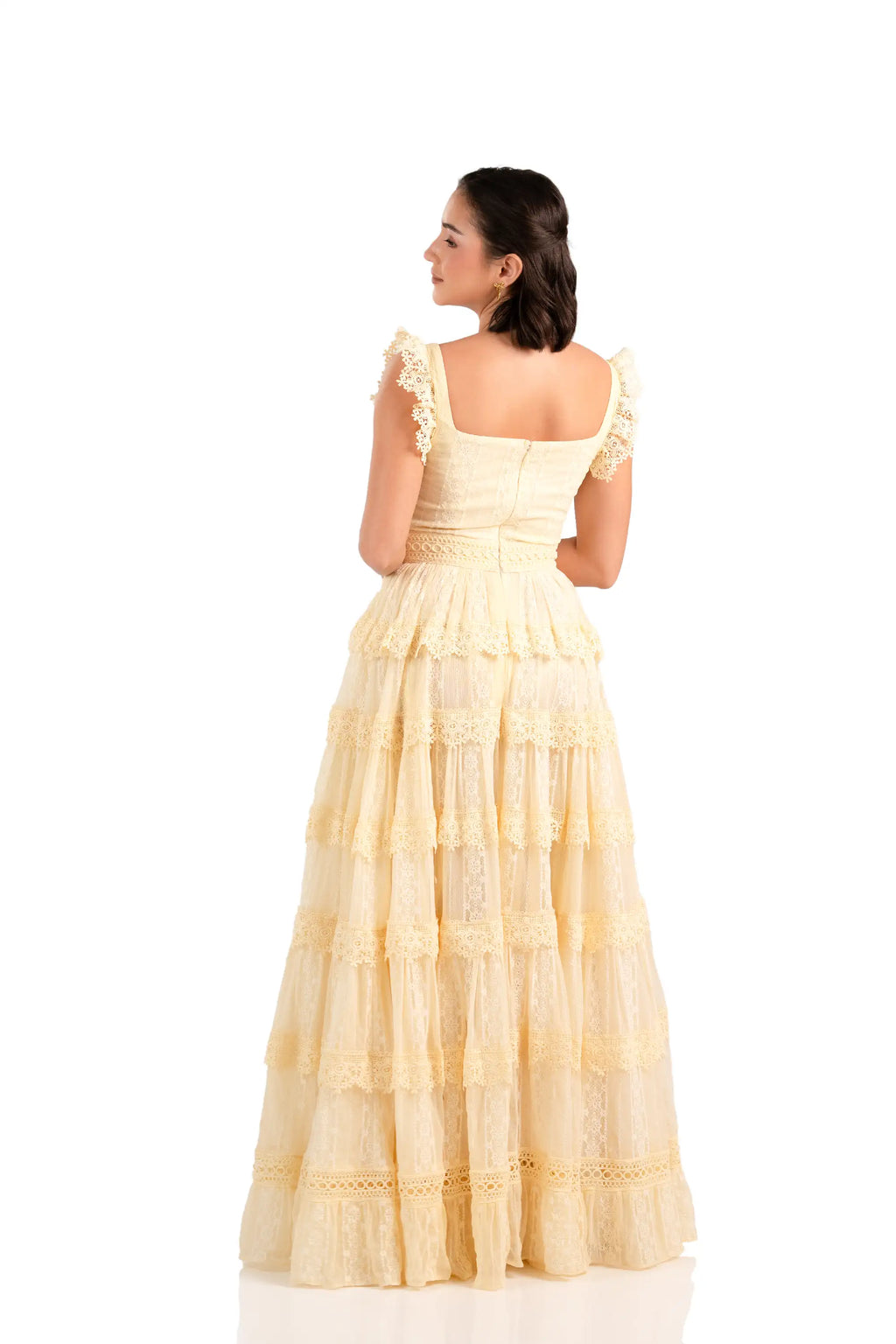 Back view of buttercream lace tiered maxi dress with square neck and ruffle straps.