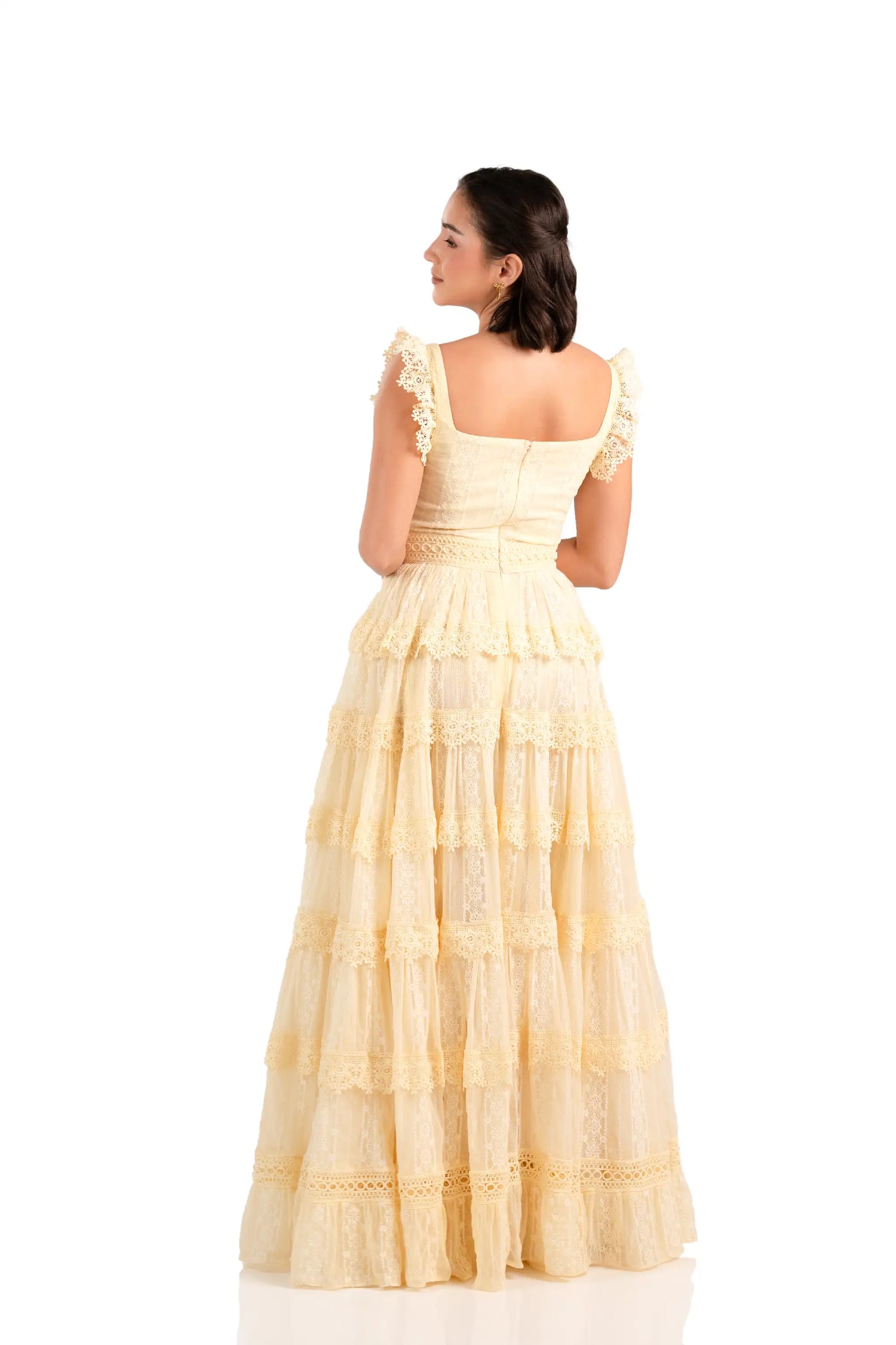 Back view of buttercream lace tiered maxi dress with square neck and ruffle straps.