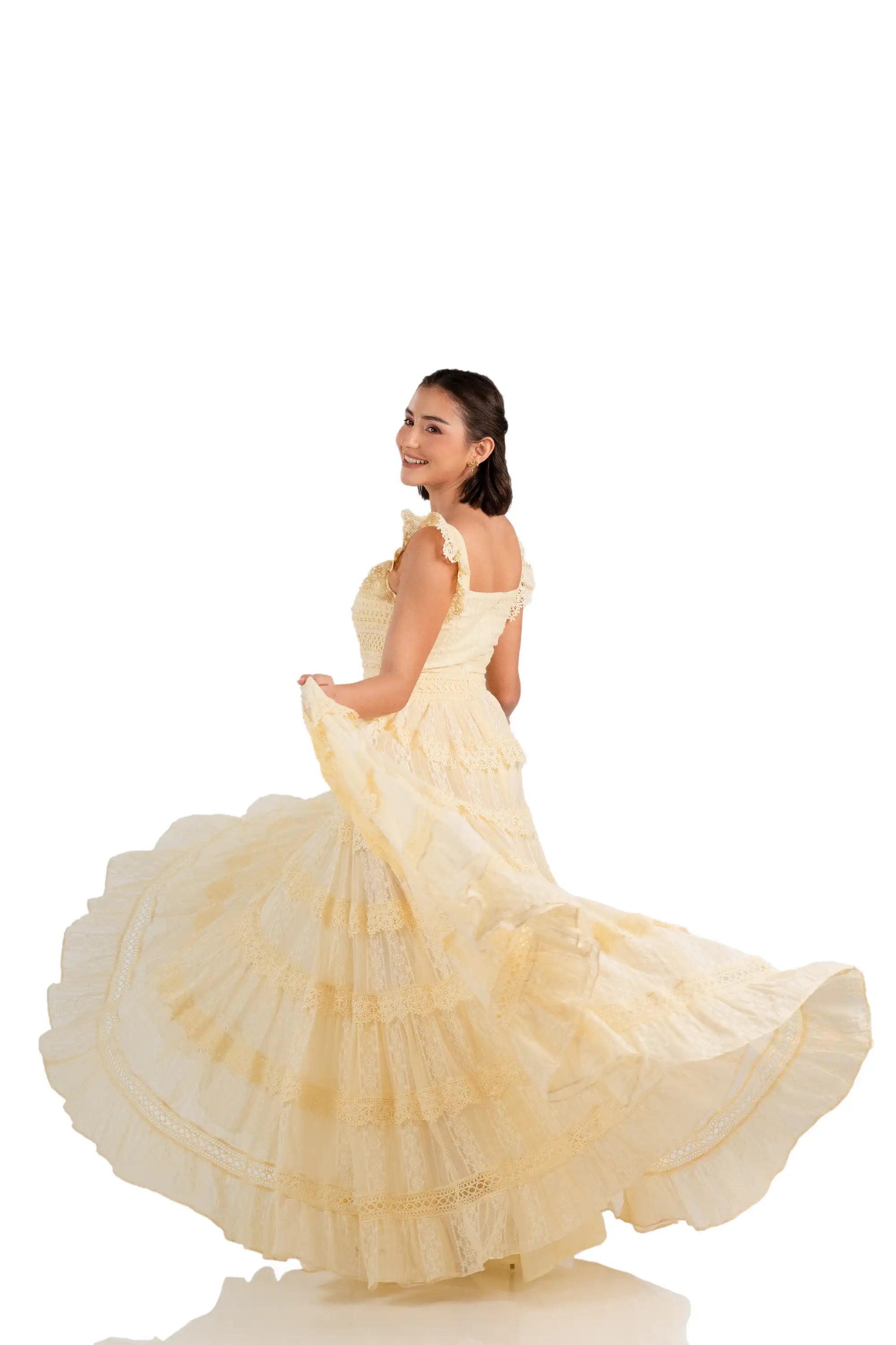 Model twirls in buttercream lace tiered maxi dress, showing flowy skirt layers.
