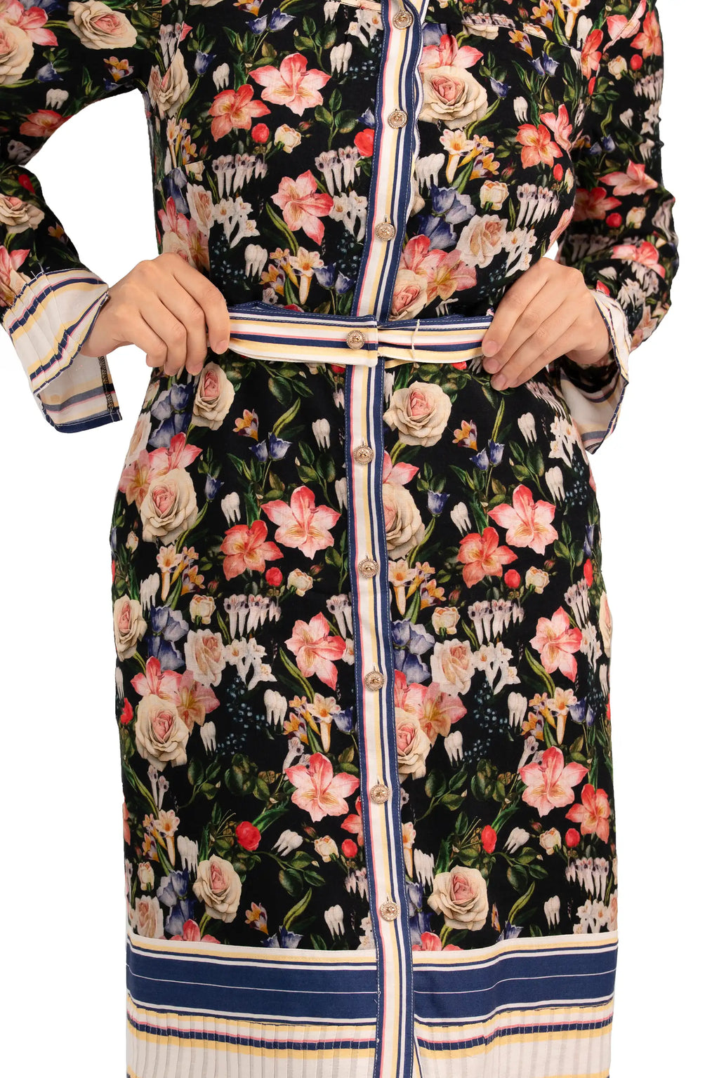 Close-up of black floral belted shirt dress showing button details, waist belt, and striped trim accents.