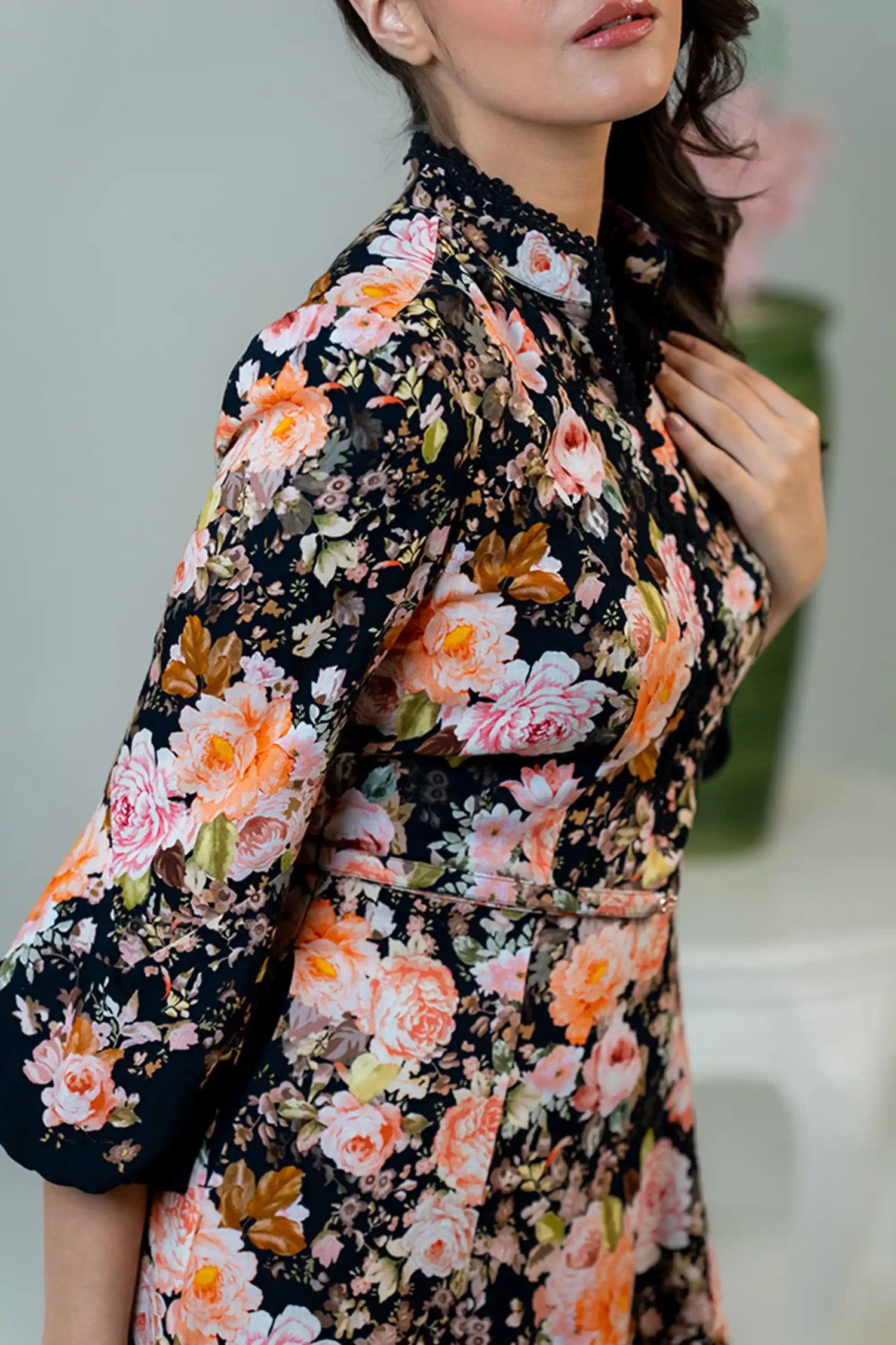 Sleeve detail of black floral midi dress with pink orange flowers