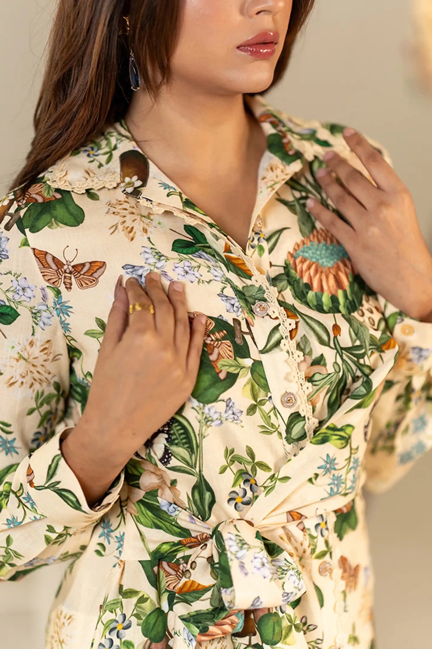 Closeup of collar and buttons on cream floral shirt dress.