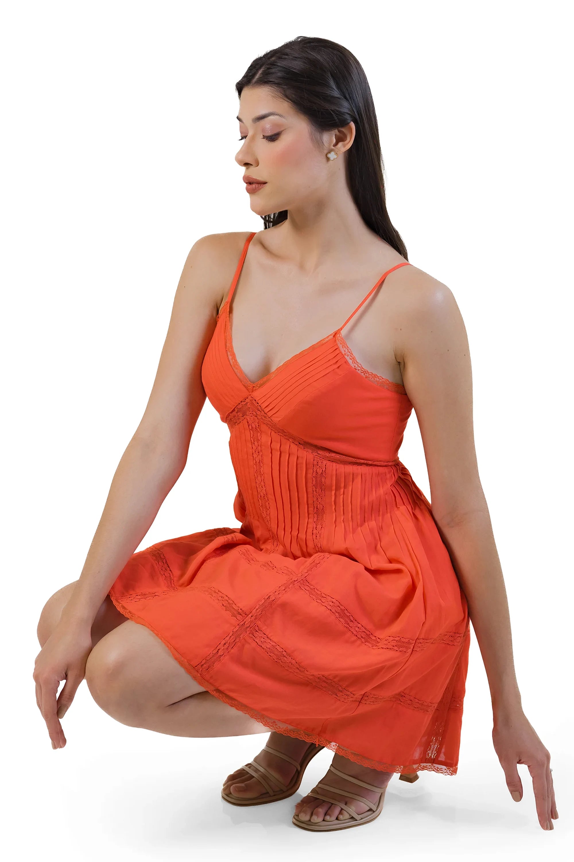 Seated view: coral spaghetti-strap mini dress, pintuck bodice