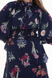 Close-up of Pretty Pixie coral orange floral collared belted wide-leg jumpsuit