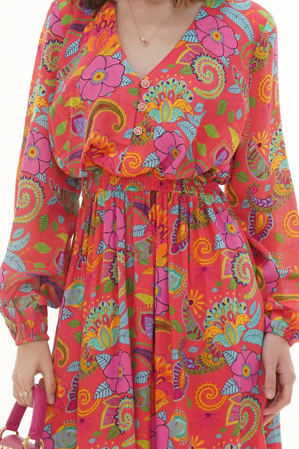 Close-up of Pretty Pixie coral paisley floral V-neck dress with crystal buttons and smocked waist