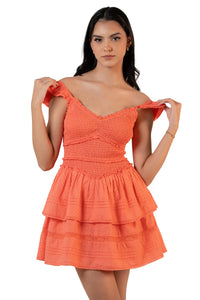 Coral smocked tiered mini dress with off-shoulder straps and layered ruffle skirt