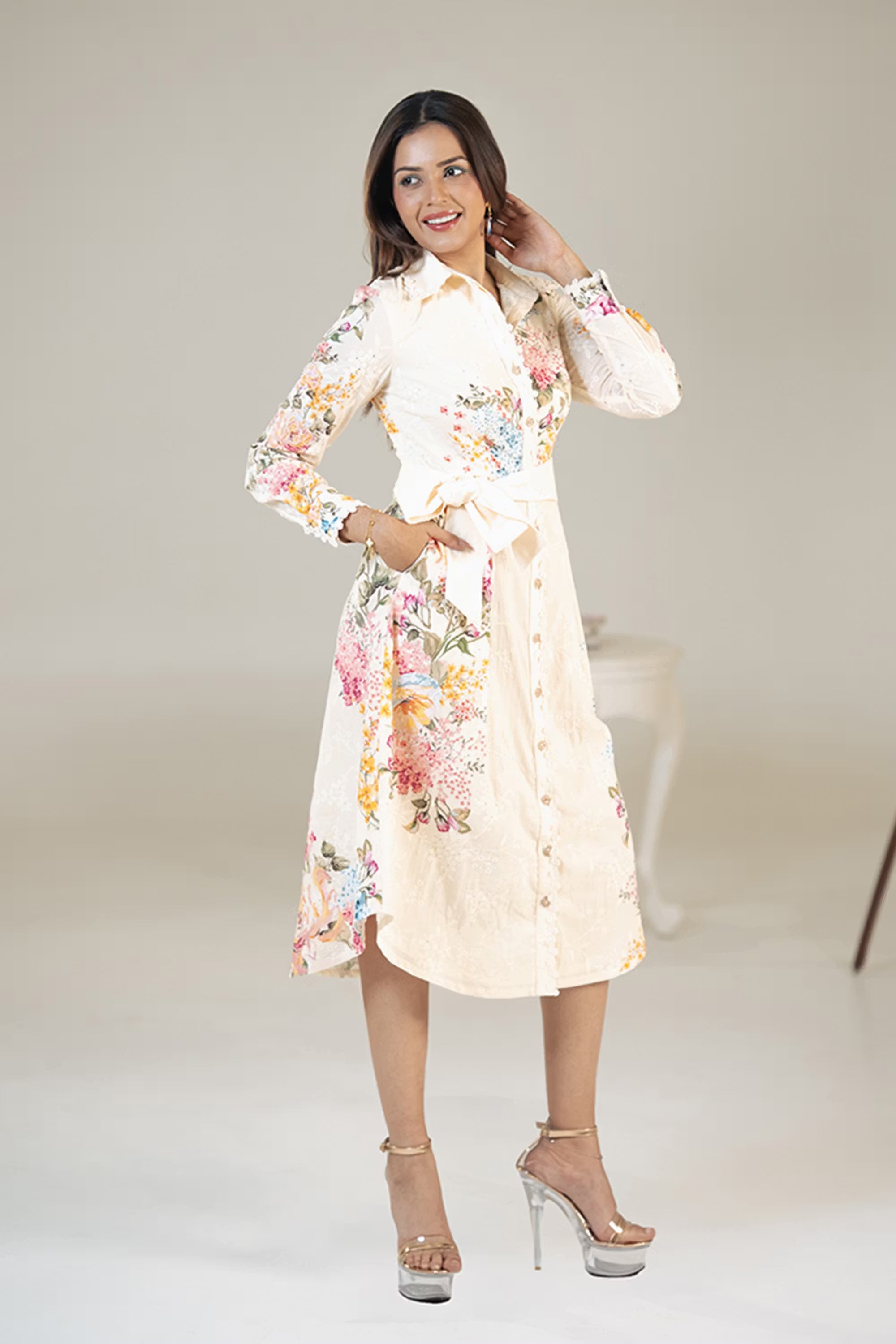 Model smiling in cream floral belted shirt dress with button-down front and waist belt