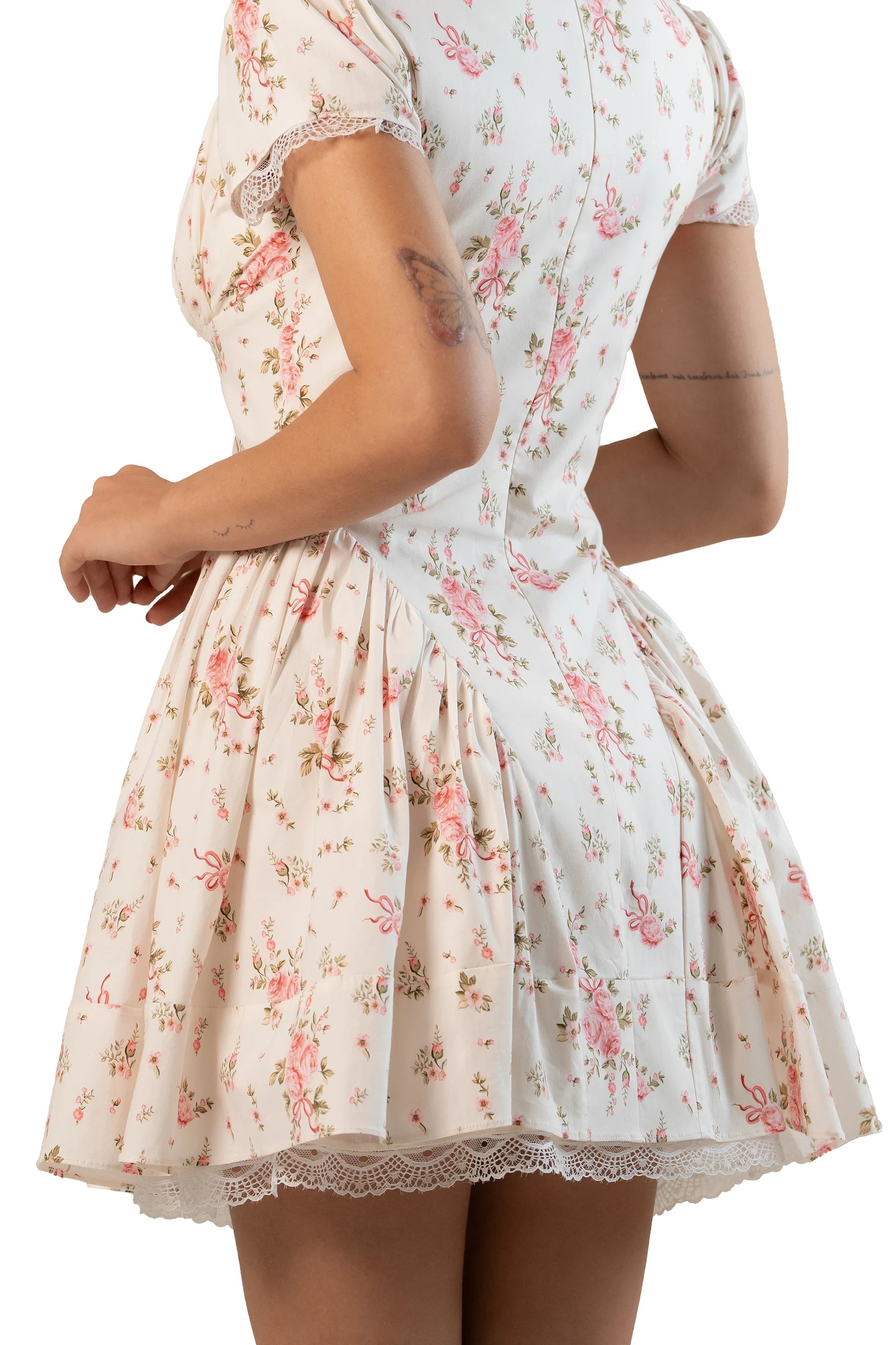Side back close-up of cream floral mini dress focusing on waist and lace-trimmed hem.