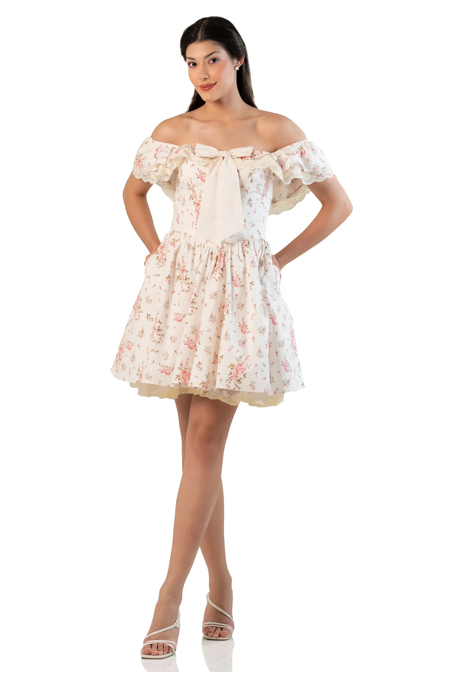 Cream floral off-shoulder mini dress with oversized bow at the chest and ruffled neckline.