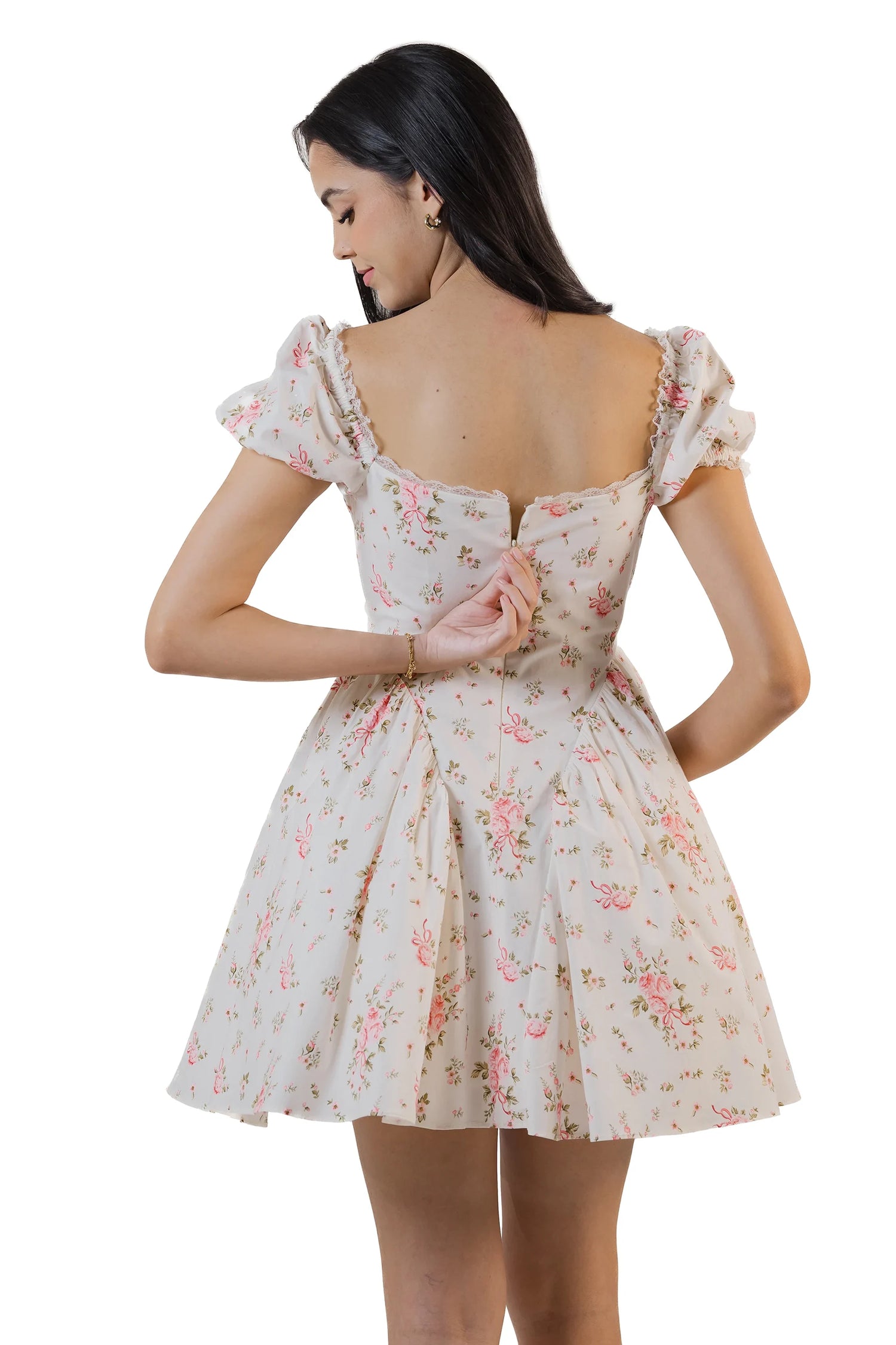 Back view of pastel floral mini dress showing bow tie at back and square neckline.