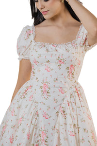 Close-up of cream white floral mini dress showing square neckline, puff sleeves, and fitted bodice.