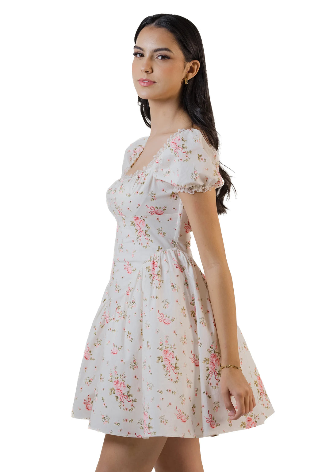 Side view of cream white floral mini dress with square neckline, puff sleeves, and flared skirt.