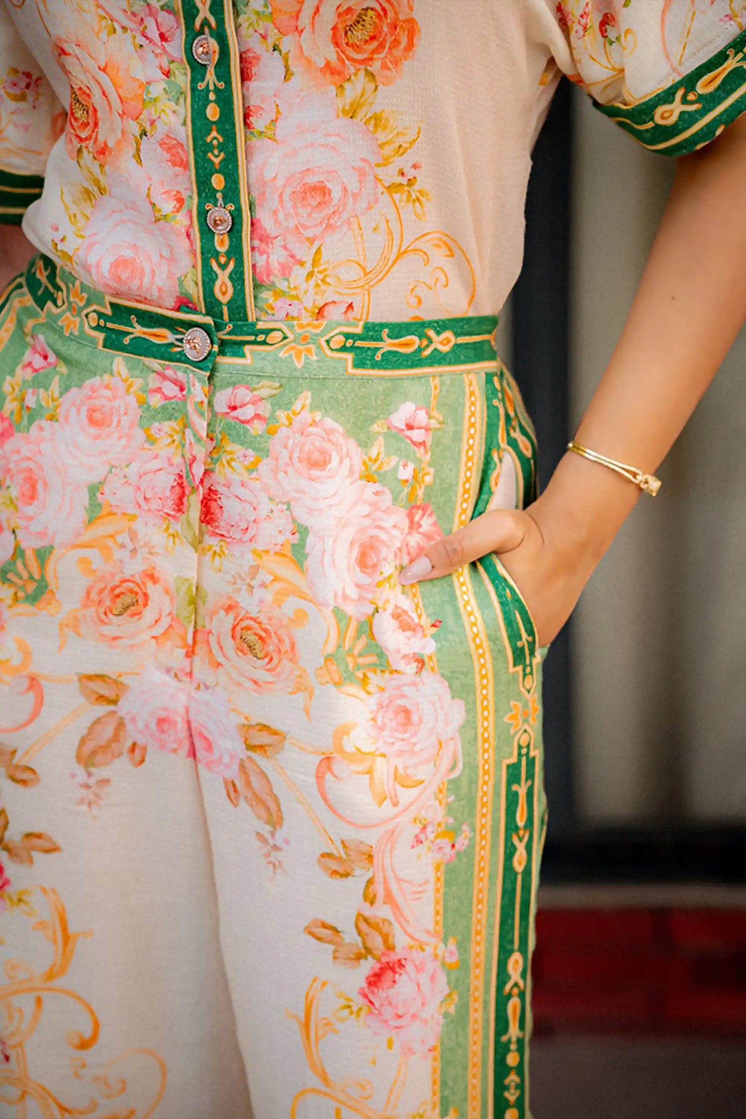 Closeup of floral co-ord set with green border and buttons