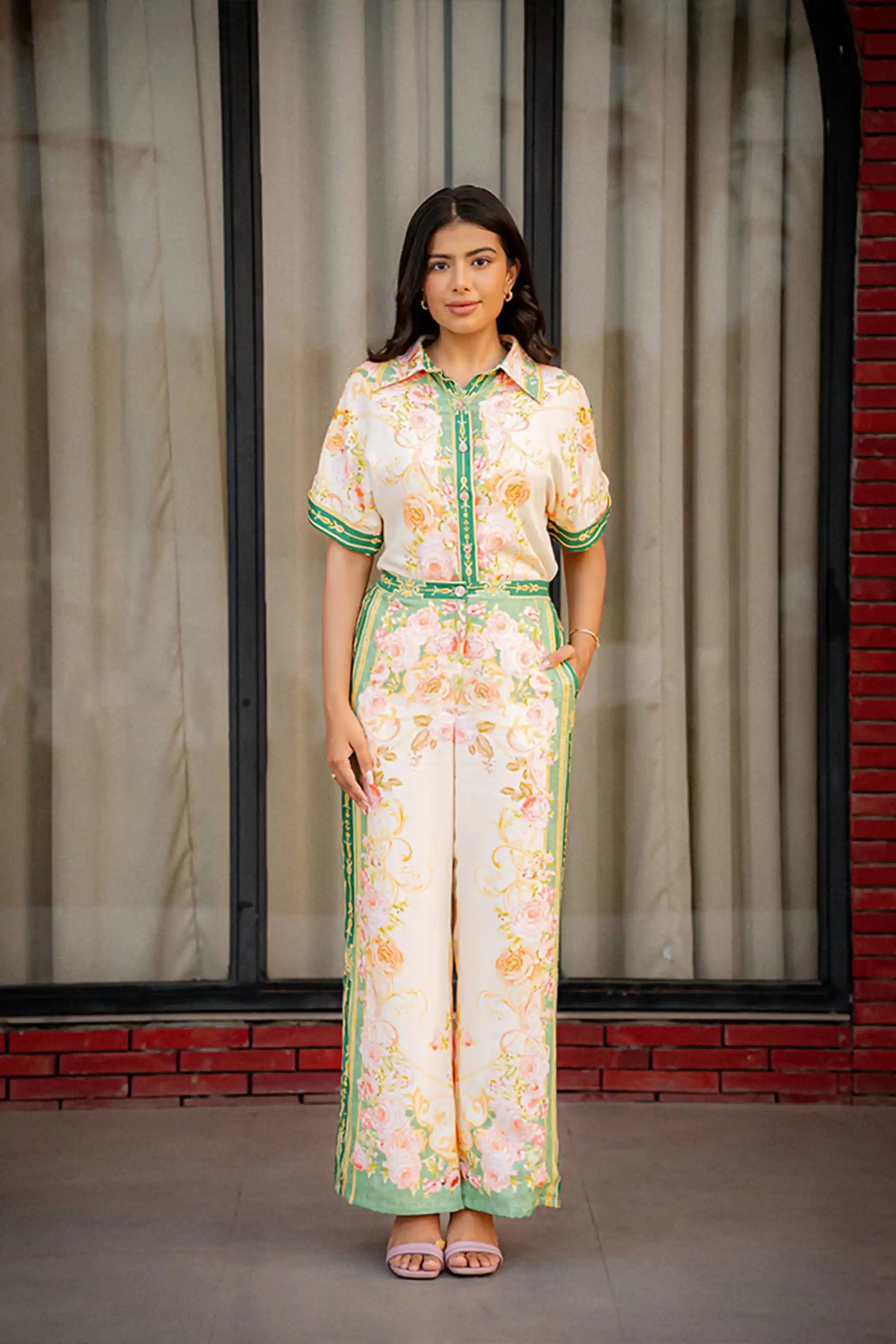 Woman wearing floral green border co-ord set front view