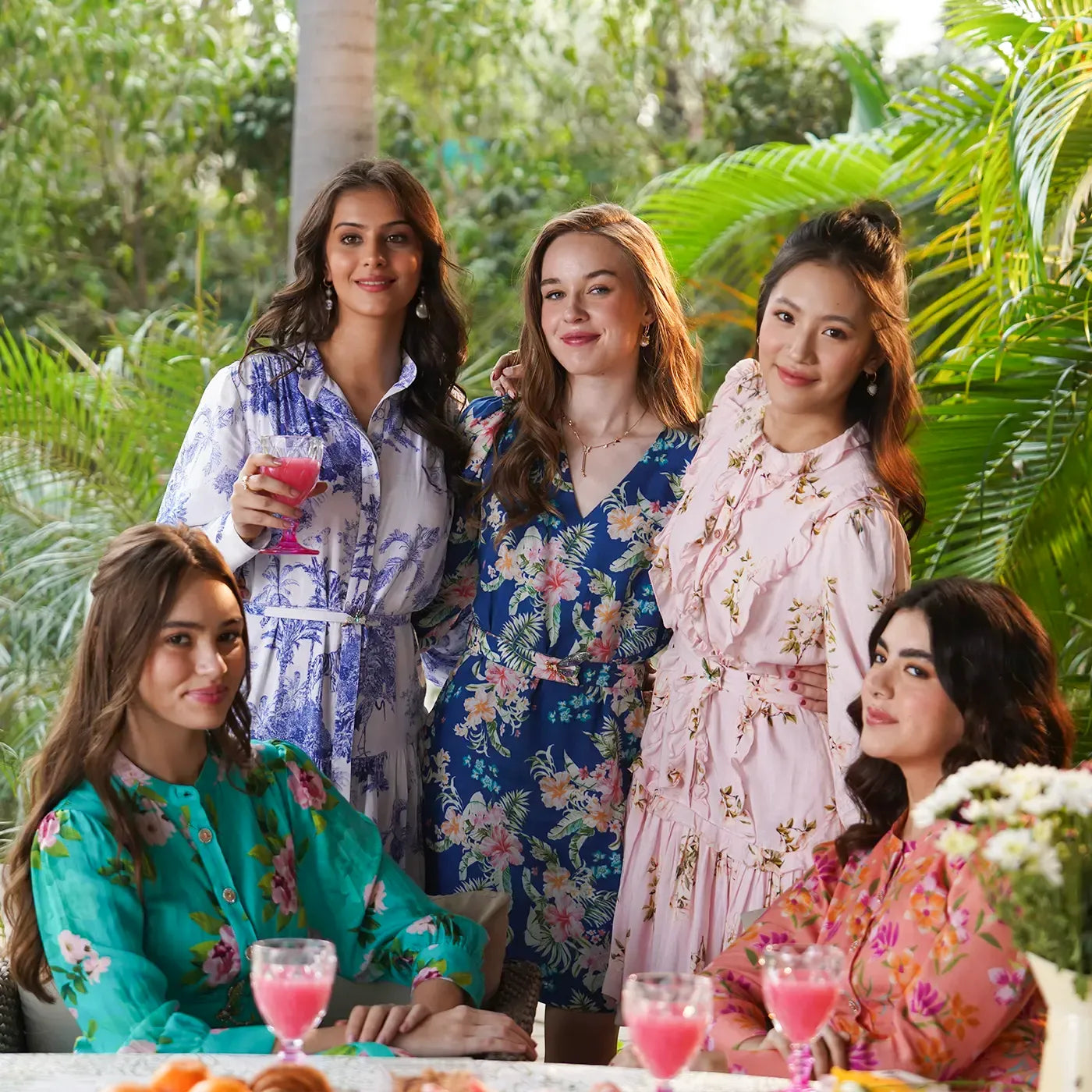 Indian women in floral midi dresses at a garden party, brunch fashion trend in India 2025.